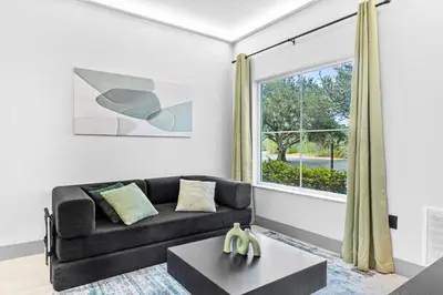 a living room with a couch and a window at 1 bedroom apartment near Disney and Universal in Orlando