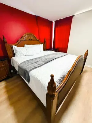a bedroom with a large bed with a red wall at 7 Bd/ 5.5 Ba- Terra Verde Resort -Near Disney in Kissimmee
