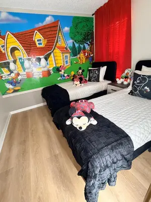 a bedroom with two beds and a mural of a house at 7 Bd/ 5.5 Ba- Terra Verde Resort -Near Disney in Kissimmee