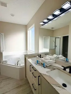 a bathroom with two sinks and a large mirror at 7 Bd/ 5.5 Ba- Terra Verde Resort -Near Disney in Kissimmee