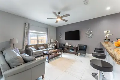 a living room with a couch and a table at Four Bedroom Private Pool Townhome, near Disney in Kissimmee