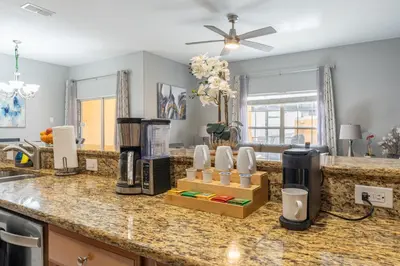 a kitchen with a counter top with a coffee maker at Four Bedroom Private Pool Townhome, near Disney in Kissimmee
