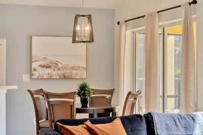 a living room with a couch and a table with chairs at Spacious 5-Bedroom 4-Bath Pool & Spa Villa in Emerald Island Resort in Kissimmee