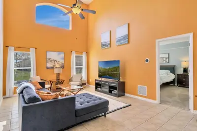 a living room with a couch and a flat screen tv at Spacious 5-Bedroom 4-Bath Pool & Spa Villa in Emerald Island Resort in Kissimmee