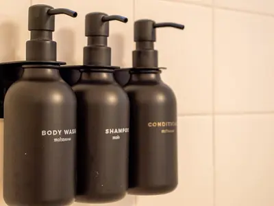 a group of three black bottles sitting on a rack at The Enchanted luxe Townhome in Kissimmee