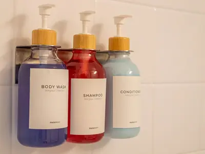 three bottles of baby wash and cologne in a refrigerator at The Enchanted luxe Townhome in Kissimmee
