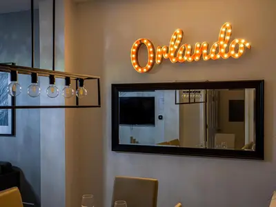 a mirror in a restaurant with a reflection of a sign at The Enchanted luxe Townhome in Kissimmee