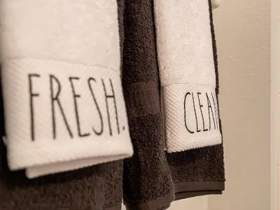 two towels with the word fresh written on them at The Enchanted luxe Townhome in Kissimmee