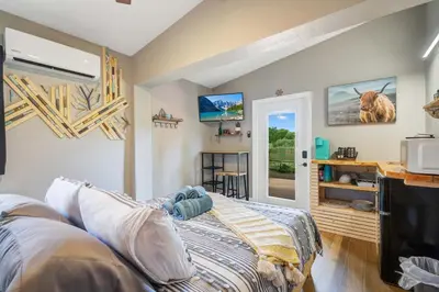 a bedroom with a bed and a tv at Lake view that is 10mins to Downtown and Parks for 2 Guests in Orlando