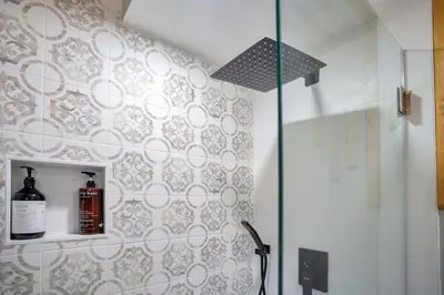 a bathroom with a shower with a glass door at Lake view that is 10mins to Downtown and Parks for 2 Guests in Orlando