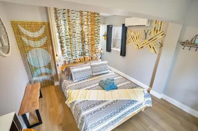 a small room with a bed and a chair at Lake view that is 10mins to Downtown and Parks for 2 Guests in Orlando