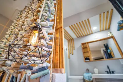 a room with a wall of wine bottles and a light at Lake view that is 10mins to Downtown and Parks for 2 Guests in Orlando