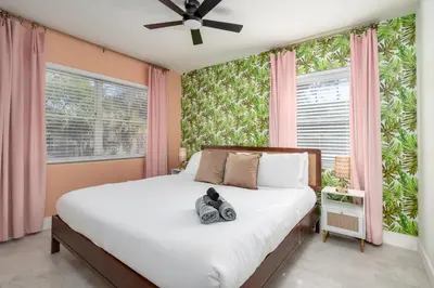 a bedroom with a bed with a camera on it at Game Filled Orlando Retreat with Patio and Grill in Orlando