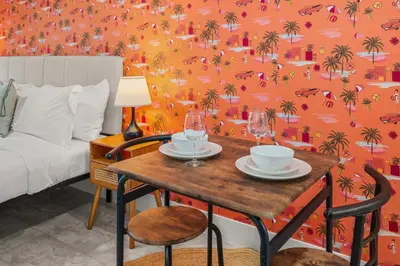 a bedroom with a table with two glasses on it at Charming Private Studio Near Everything Orlando in Orlando