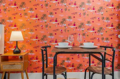 an orange wallpaper with palm trees and birds at Charming Private Studio Near Everything Orlando in Orlando