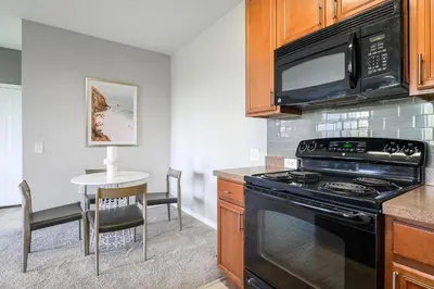a kitchen with a stove and a microwave at Landing Stunning 2BD Yoga Studio Gym in Kissimmee