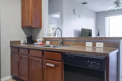 a kitchen with a sink and a dishwasher at Landing Stunning 2BD Yoga Studio Gym in Kissimmee