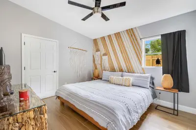 a bedroom with a bed and a ceiling fan at Fireplace and Lake View Just 10 Minutes to Downtown Near Parks in Orlando