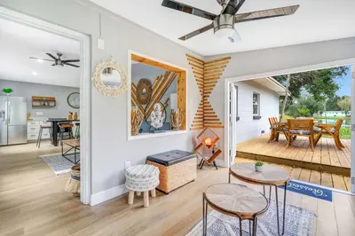 a living room with a dining room and a kitchen at Fireplace and Lake View Just 10 Minutes to Downtown Near Parks in Orlando
