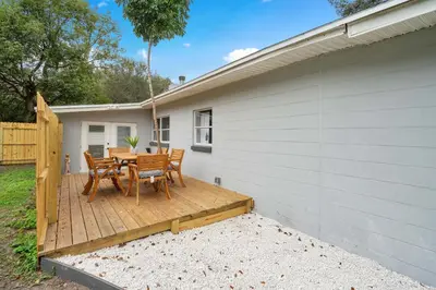 a patio with a table and chairs on a deck at Fireplace and Lake View Just 10 Minutes to Downtown Near Parks in Orlando