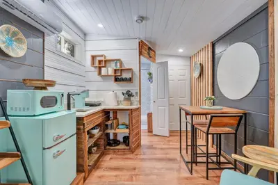 a kitchen with a blue refrigerator and a table at Peaceful Lake View Retreat Near Parks 10 Minutes to Downtown in Orlando