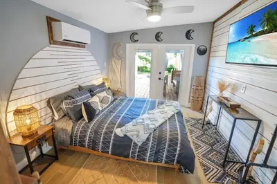 a bedroom with a bed with a wooden head board at Peaceful Lake View Retreat Near Parks 10 Minutes to Downtown in Orlando