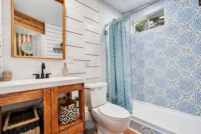 a bathroom with a toilet and a sink and a shower at Peaceful Lake View Retreat Near Parks 10 Minutes to Downtown in Orlando