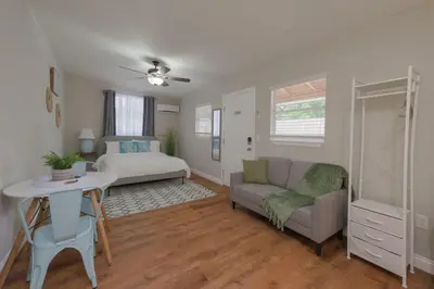 a living room with a bed and a couch at Studio in the heart of Orlando in Orlando