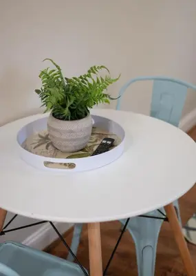 a white table with a potted plant on it at Studio in the heart of Orlando in Orlando