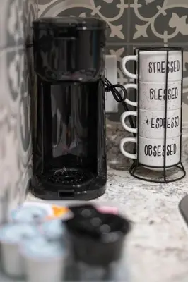 a black coffee mug sitting on top of a counter at Studio in the heart of Orlando in Orlando