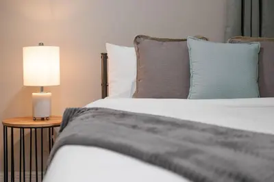 a bedroom with two beds and a lamp on a table at Comfy studio in Central Orlando in Orlando