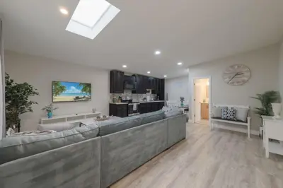 a living room with a couch and a dining room at Cozy 2 bedroom home in Orlando in Orlando