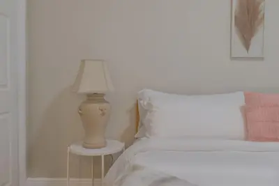 a bedroom with a bed with a lamp on a table at Cozy 2 bedroom home in Orlando in Orlando