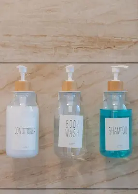 a group of three bottles of soap on a wall at Cozy 2 bedroom home in Orlando in Orlando
