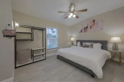 a bedroom with a bed and a ceiling fan at Private Studio near parks and Downtown in Orlando