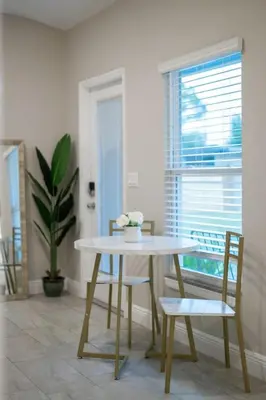 a table and chairs in a room with a window at Private Studio near parks and Downtown in Orlando