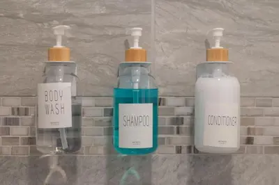 three bottles sitting on a counter in a bathroom at Private Studio near parks and Downtown in Orlando