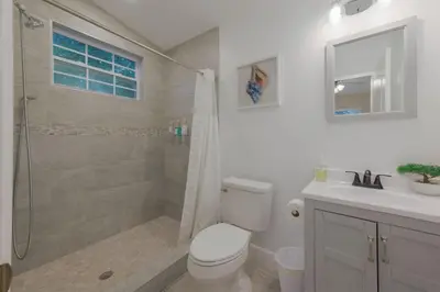 a bathroom with a shower and a toilet and a sink at Private Studio near parks and Downtown in Orlando
