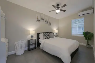 a white bedroom with a bed and a ceiling fan at Comfortable 1 bedroom home in Orlando