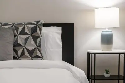 a bedroom with a bed and a lamp on a table at Comfortable 1 bedroom home in Orlando