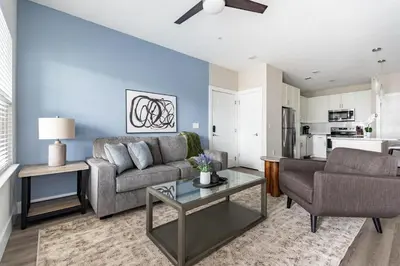 a living room with a couch and a table at Landing Incredible 1BD Clubhouse Gym in Orlando