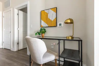 a desk with a chair and a lamp in a room at Landing Incredible 1BD Clubhouse Gym in Orlando
