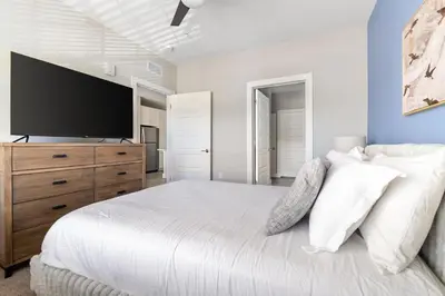 a bedroom with a large bed with a flat screen tv at Landing Incredible 1BD Clubhouse Gym in Orlando