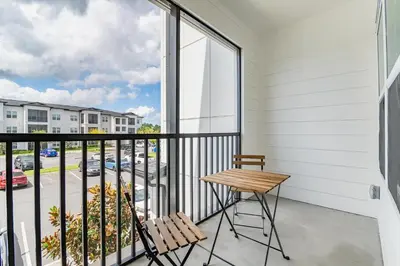a balcony with a table and chairs and a view of a street at Landing Incredible 1BD Clubhouse Gym in Orlando