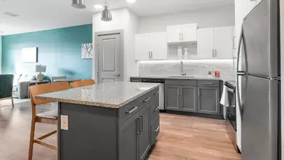 a kitchen with a counter and a refrigerator at Landing Chic 1BD Gym Pool in Sanford