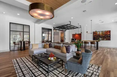 a living room with a couch and a table at Landing Chic 1BD Gym Pool in Sanford