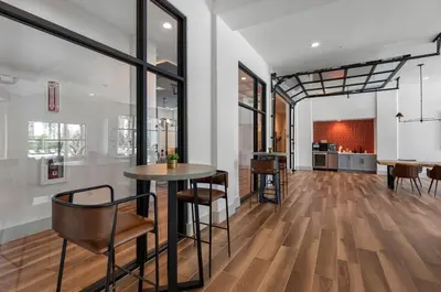 a room with a table and chairs and a kitchen at Landing Chic 1BD Gym Pool in Sanford
