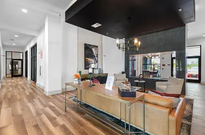 a living room with a couch and a table at Landing Chic 1BD Gym Pool in Sanford
