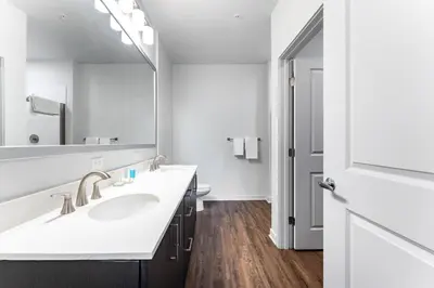 a bathroom with a sink and a large mirror at Landing Beautiful 2BD in Kissimmee in Kissimmee