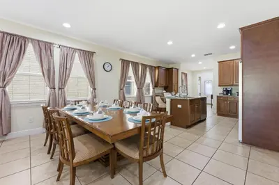 a kitchen and dining room with a table and chairs at Encore Resort luxury house 8 bedrooms, pool and spa in Orlando